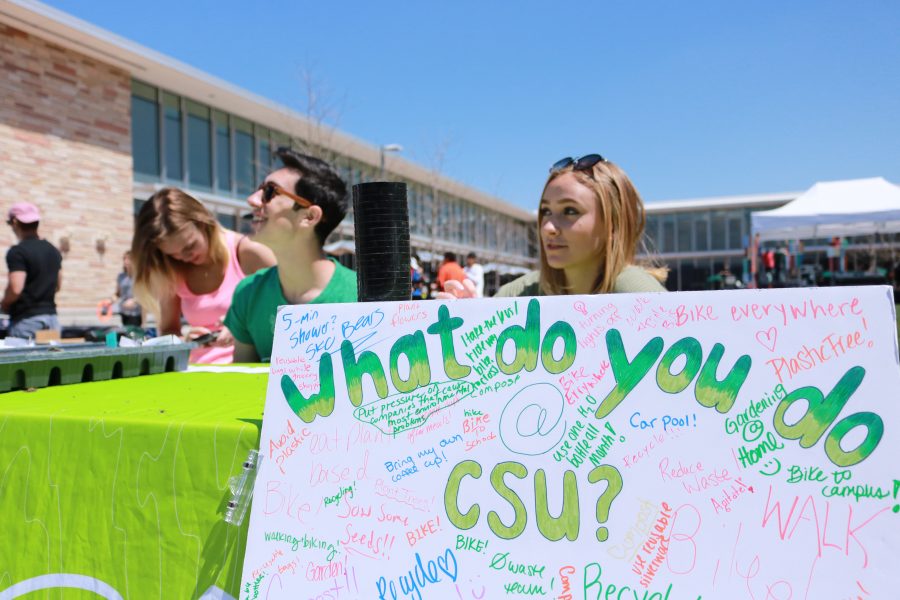 CSU Eco leaders Ren Bergeron, Noah Fishman and Sophie Bell smile at their booth during the Earth day celebration. They asked students what the do to help protect the environment. (Devin Cornelius | Collegian)