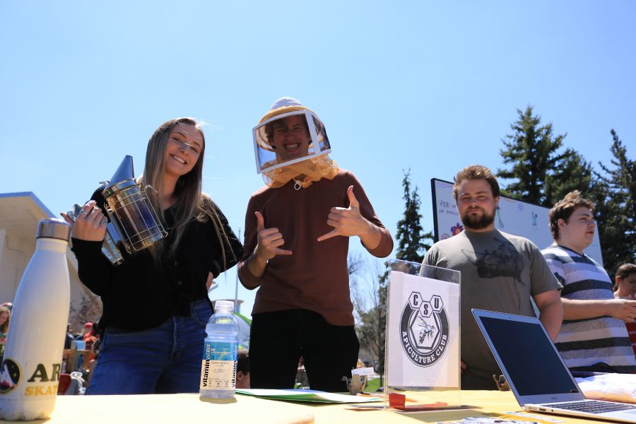 Shannon Kinsella, Freddie Haberecht, and Nolan Bunting pose for the camera while working a booth about bees at the CSU Earth Day Celebration. (Devin Cornelius | Collegian)