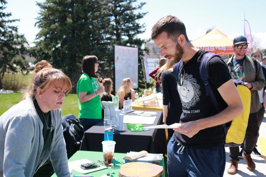 Cassie Mattson listens to Joel Hafnor's question about forest preservation at the Earth day celebration (Devin Cornelius | Collegian)