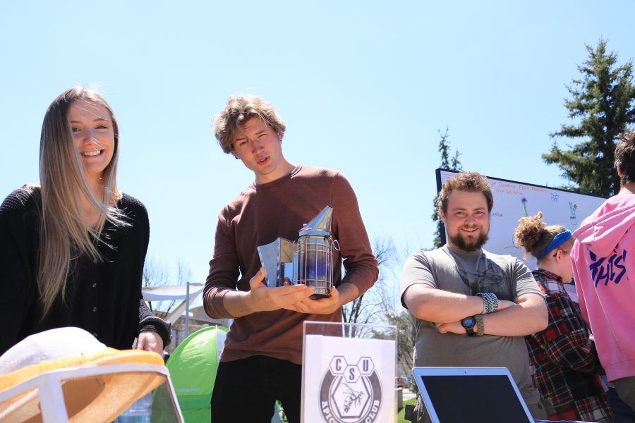 Shannon Kinsella, Freddie Haberecht, and Nolan Bunting pose for the camera while working a booth about bees at the CSU Earth Day Celebration.  Freddie said that "Bees are great ambassadors for the environment". (Devin Cornelius | Collegian)