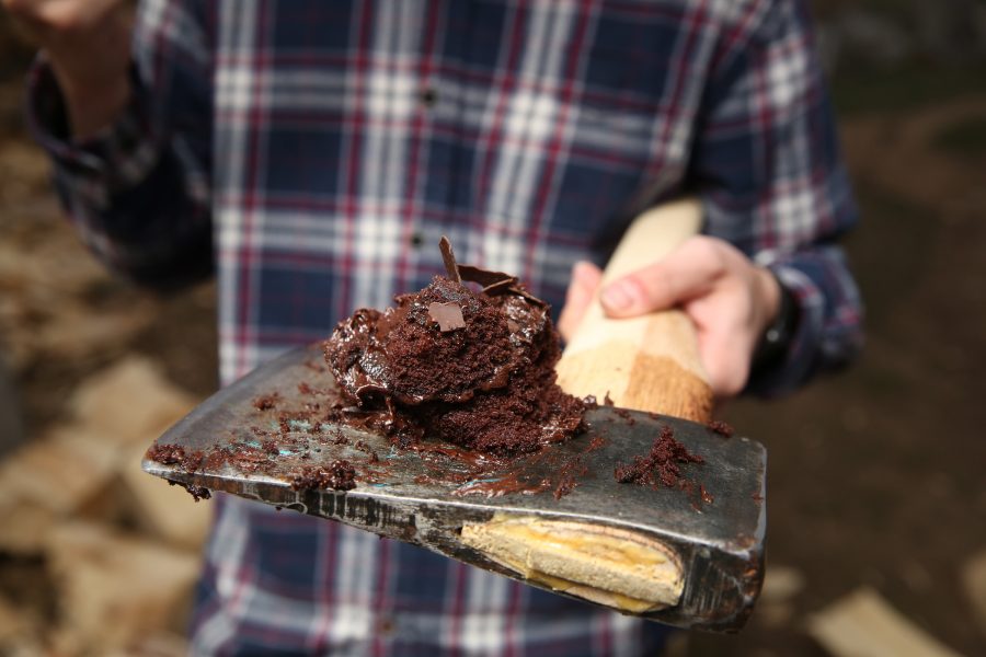 Chase Cessna shows off a piece of birthday cake on an axe at one of the Colorado State University logging team's recent practices. The team was celebrating Cessna's recent birthday. (Forrest Czarnecki | College Avenue)