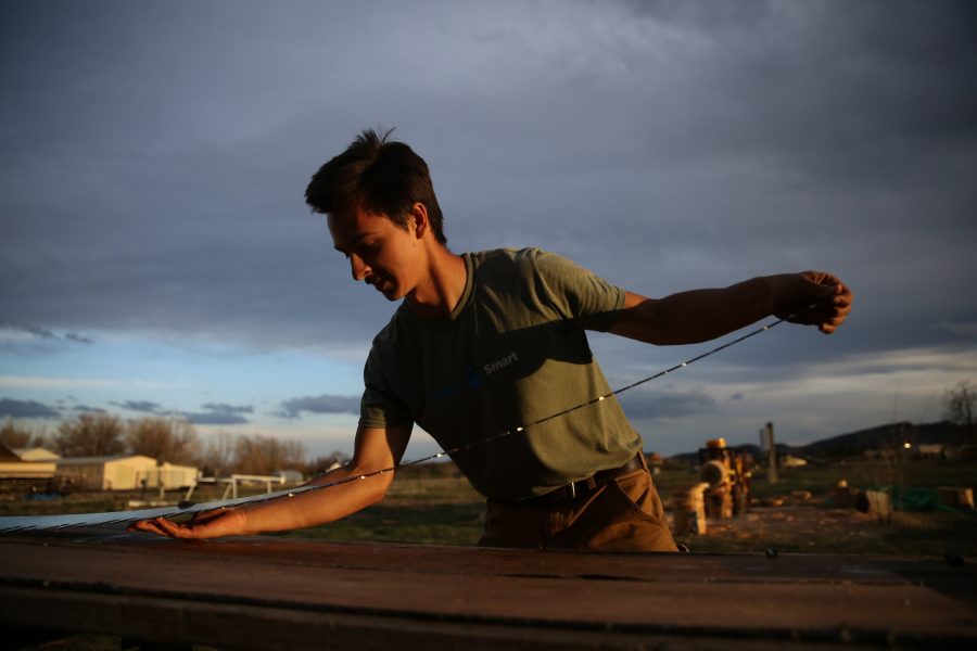 Galen Burr applies WD-40 to a crosscut saw following on the Colorado State University logging team's practices. (Forrest Czarnecki | College Avenue)