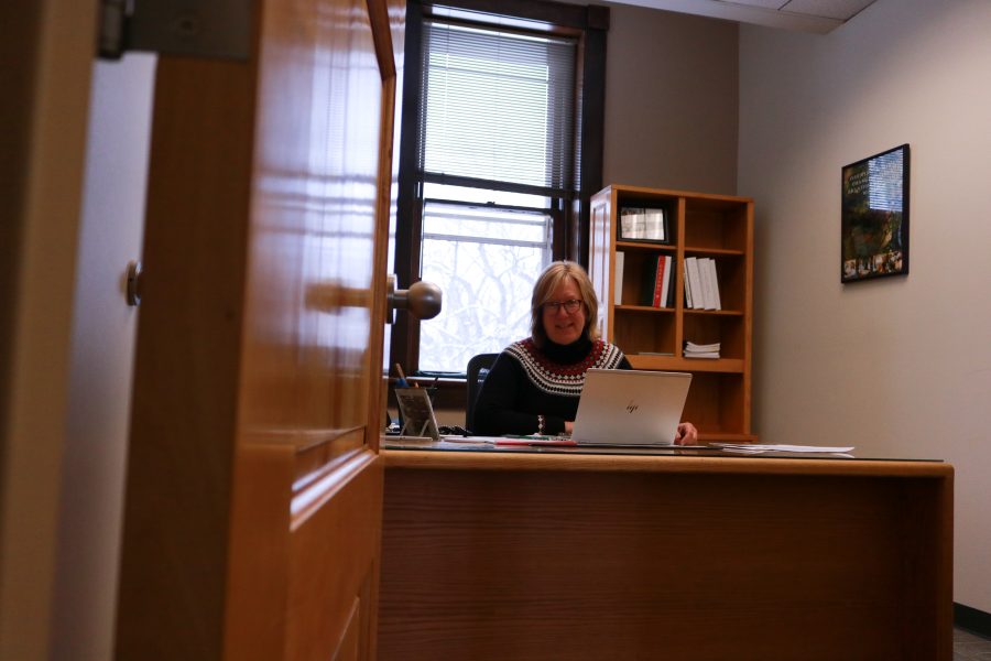 Lise Youngblade smiles for a photo while working on her computer. She will be the new Dean of the College of Health and Human Sciences starting August fifth.