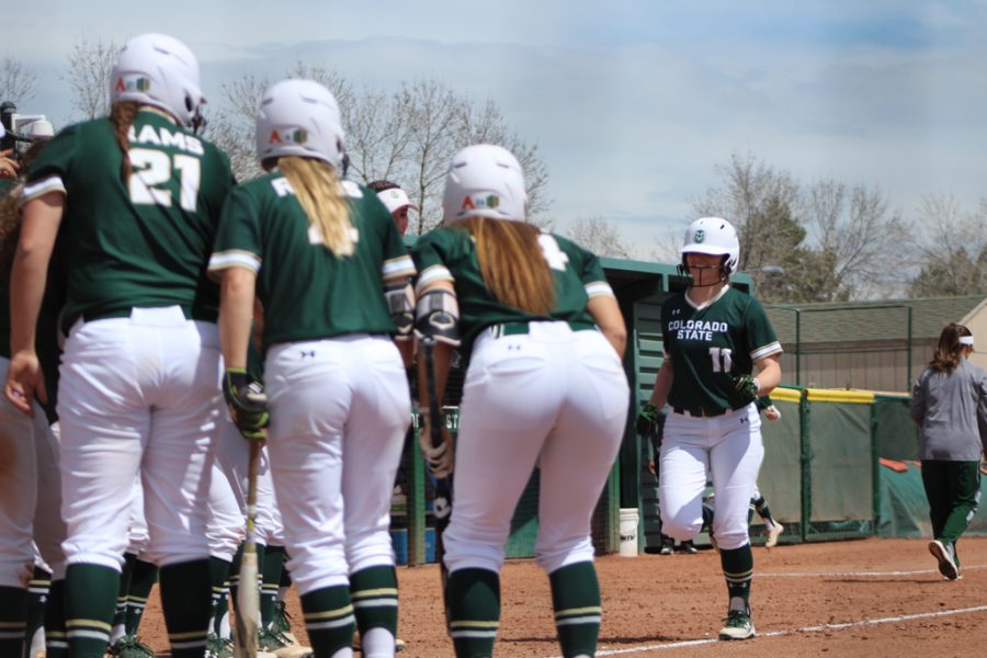 The Rams storm home base and celebrate as Sophomore, Tara Shadowen sends a homerun over the fence, giving the Rams a two run lead in the third inning. (Joshua Contreras | Collegian).