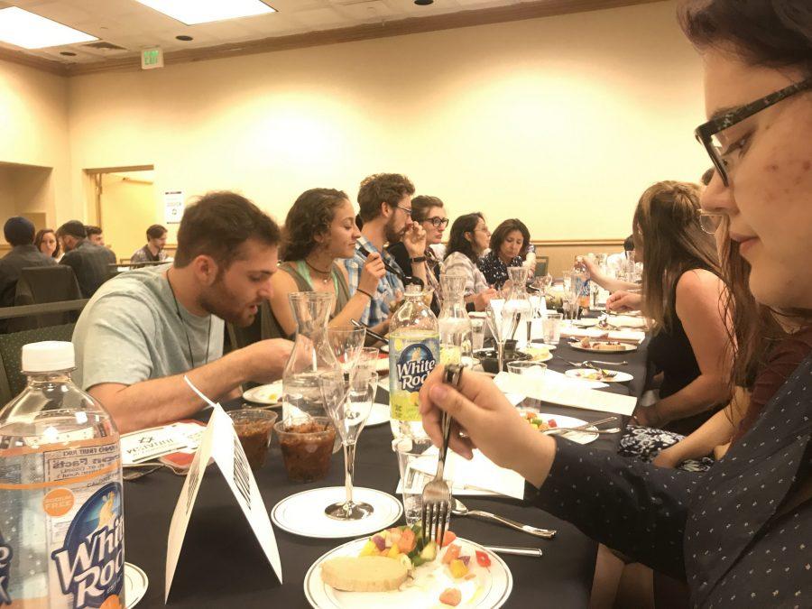 Participants of CSUs Passover Seder event hosted by the Chabad Jewish Student Organization enjoy salad and fish appetizers before the offical Seder event beings. All photos were taken before sunset in accordance with Jewish tradition.