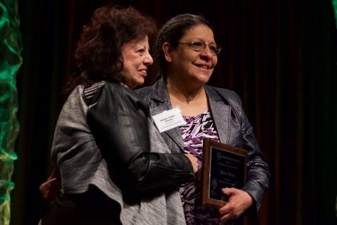 Patricia Vigil gives Alfreda “Freda” Whaley, a residential dining employee, the Multicultural Staff and Faculty Network