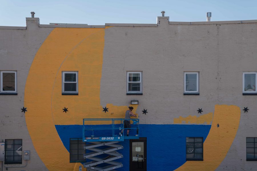 Max Coleman, a traveling artist from Connecticut, works on his mural July 29, 2019. Coleman takes past techniques and elements and applies them to modern styles. He had one of the largest scale projects in the 2019 FC Mural Project.