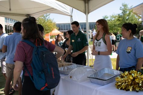 CSU students Taylor Millson and Linzhi Douglass welcome students to the annual Grill the Buffs barbecue outside the Lory Student Center Aug. 28, 2019. (Anna von Pechmann | Collegian) 