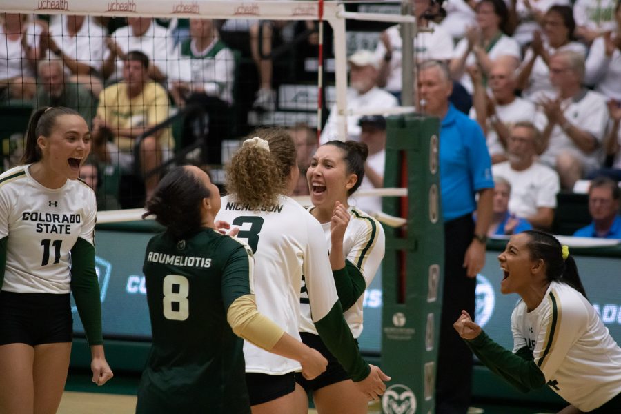 Paulina Hougaard-Jensen (11), Alexis Roumeliotis (8), Olivia Nicholson (3) Katie Oleksak (22) and Brooke Hudson (4) celebrate after scoring against the Sooners, during their home whiteout game. CSU defeats OU winning three sets to zero. (Devin Cornelius | Collegian)