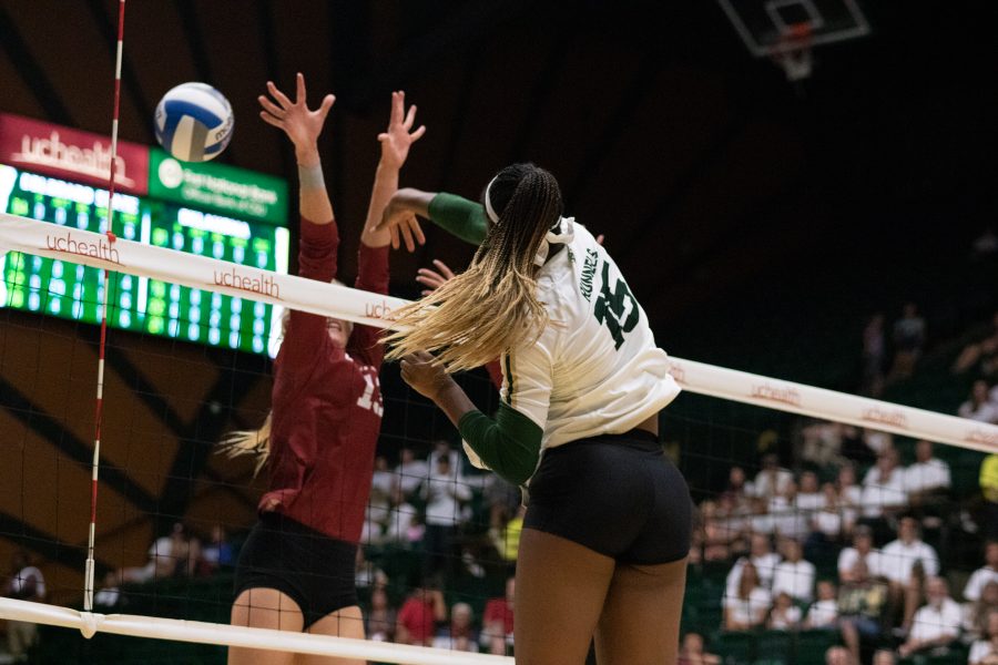 Breana Runnels (15) hits the ball past a defender, as CSU battles OU during their whiteout home game. CSU defeats OU three sets to zero. (Devin Cornelius | Collegian)
