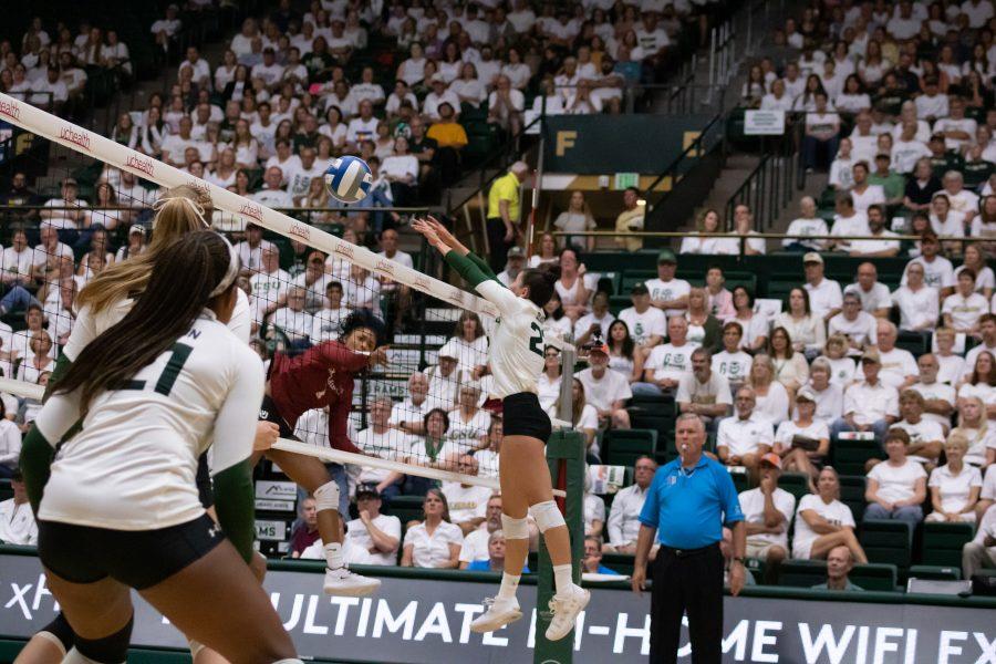 Katie Oleksak (22) bats the ball back towards the OU defenders during CSU's whiteout home game. CSU sweeps OU three sets to zero (Devin Cornelius | Collegian)