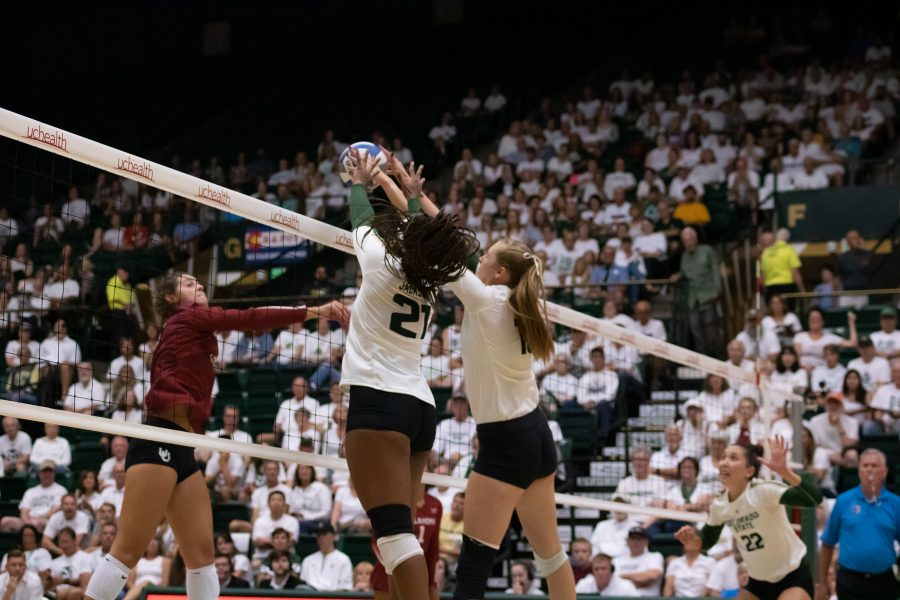 Jessica Jackson (21) and Kirstie Hillyer (13) leap us to block the ball as CSU battles OU. CSU wins three sets to zero. (Devin Cornelius | Collegian)