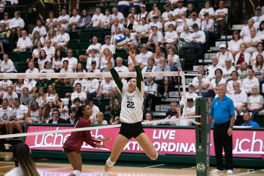 Katie Oleksak (22) jump sets Breana Runnels (15) during CSU's whiteout home game against Oklahoma University. CSU wins three sets to zero. (Devin Cornelius | Collegian)