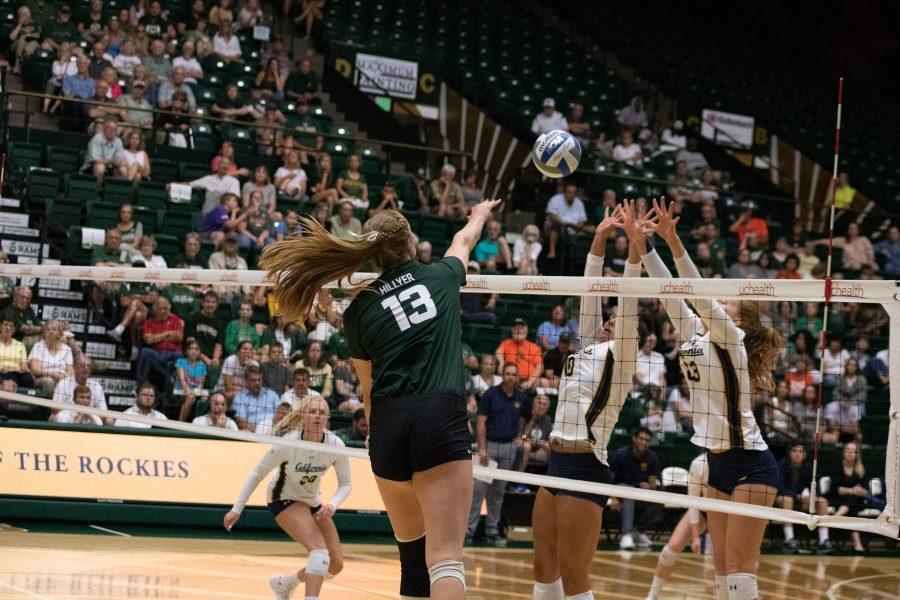 Kristie Hillyer (13) Spikes the ball down onto the Golden Bears defense, in Moby Arena. CSU loses the match to CAL three sets to one. (Devin Cornelius | Collegian)