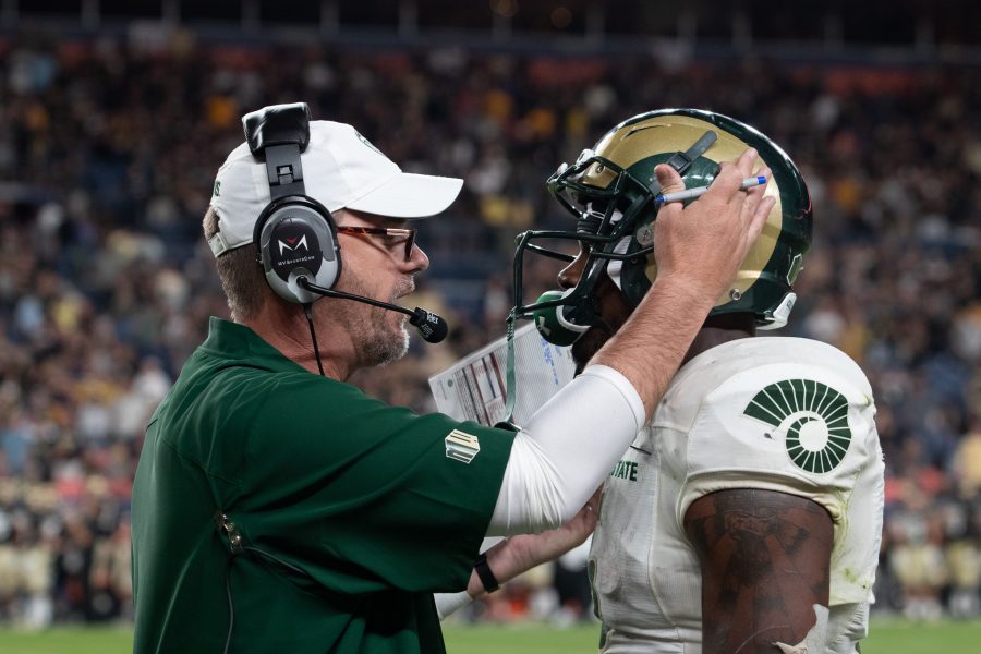 Former Colorado State University head coach Mike Bobo talks with running back Marvin Kinsey Jr. on the sidelines at the Rocky Mountain Showdown Aug. 31. (Anna von Pechmann | The Collegian) 
