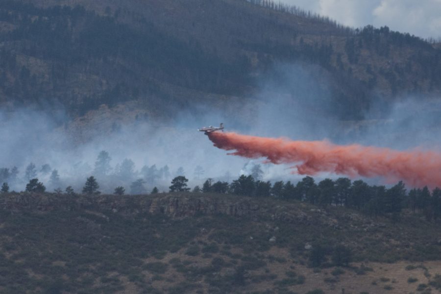 A slurry plane drops fire retardant on the Skyline Fire near Horsetooth Reservoir Sept. 5. A suspect is in custody for charges of arson relating to the fire. (Matt Tackett | The Collegian)