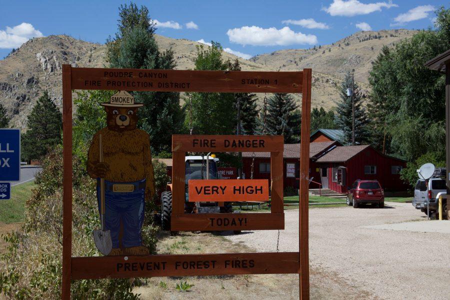 A sign featuring Smokey Bear warns drivers of a high fire danger in Poudre Canyon Sept. 1, 2019. Although fires are sometimes healthy for an ecosystem, it is often important to reduce the risk of them. (Ryan Schmidt | Collegian)