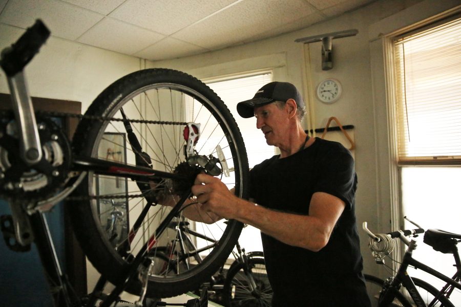 David Stitzel works on refurbishing a bike in his home near Colorado State Universitys campus in central Fort Collins. Stitzel refurbishes and fixes bikes that he later donates to people in need through a partnership with the FoCo Cafe. (Forrest Czarnecki | The Collegian)