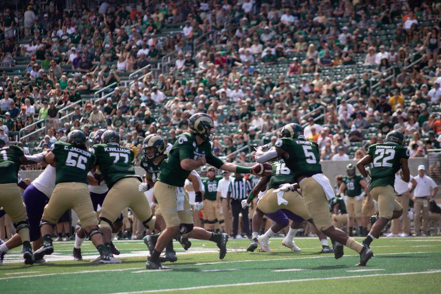 Collin Hill (15) gives the hand off to Marvin Kinsey Jr.  (5) during Colorado States Home opener against Western Illinois. CSU wins 38-13. (Devin Cornelius | Collegian)