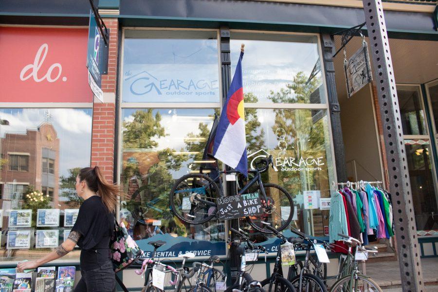 Woman walks by The Gearage store front in Old Town, Fort Collins on Sept. 10. (Anna von Pechmann | Collegian) 