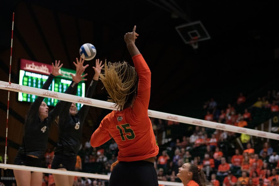 Breana Runnels (15) spikes the ball towards the University of Colorado Boulder defenders, during the Colorado State Orange Out home game against the Buffs. The Rams win three sets to zero. (Devin Cornelius | Collegian)