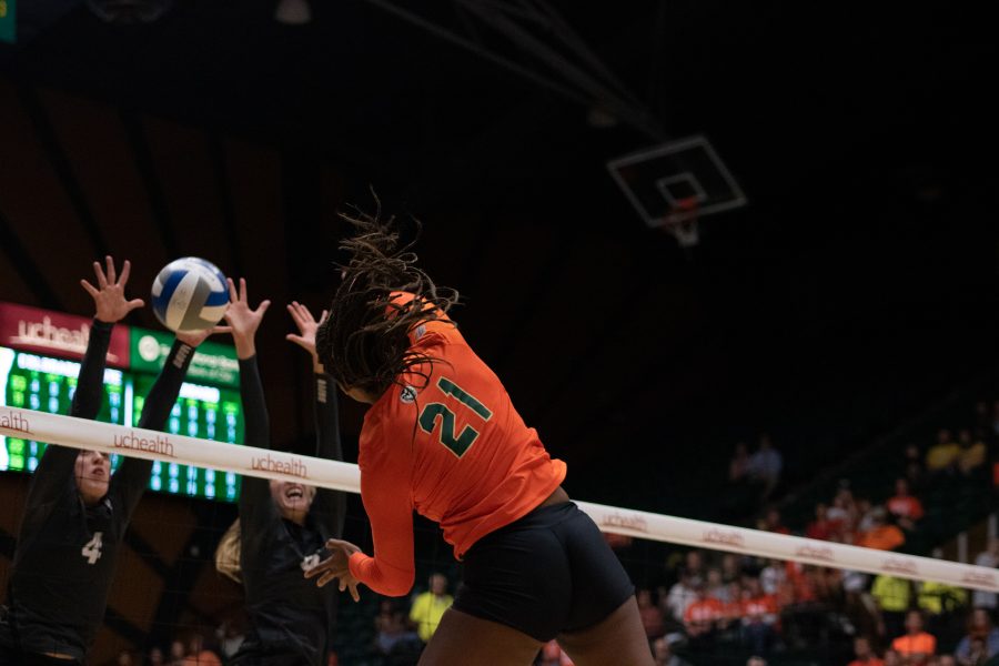 Jessica Jackson(21) spikes the ball down on her opponents, as the Colorado State Rams take on the University of Colorado Boulder Buffs at home. The Rams defeat the Buffs three sets to zero. (Devin Cornelius | Collegian)