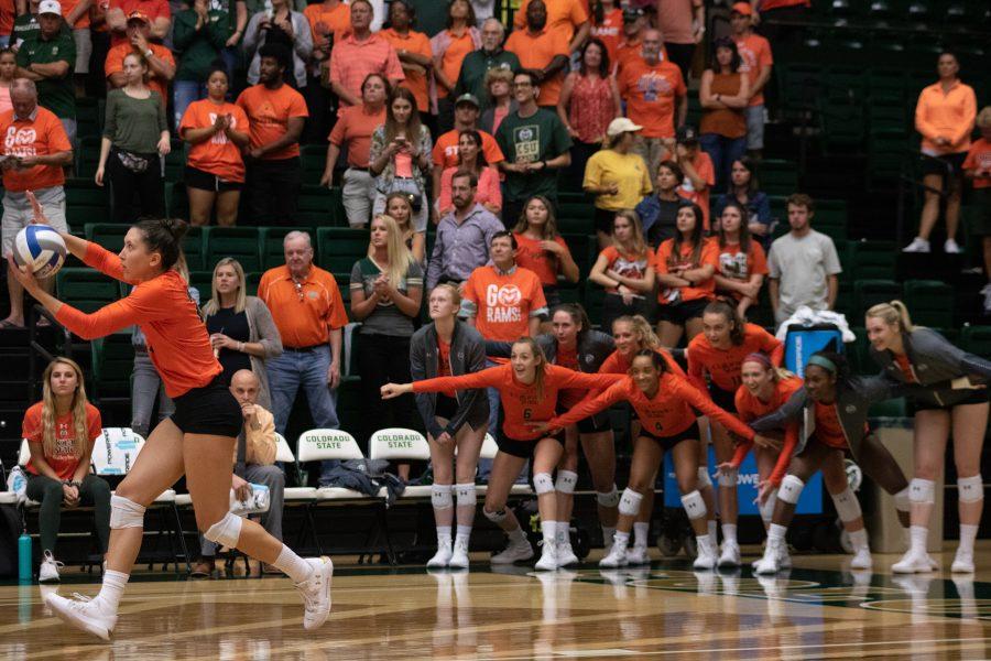 The Colorado State volleyball players watch Katie Oleksak (22) as she serves during game point of the Rams' match against the University of Colorado Boulder. The Rams win three sets to zero. (Devin Cornelius | Collegian)