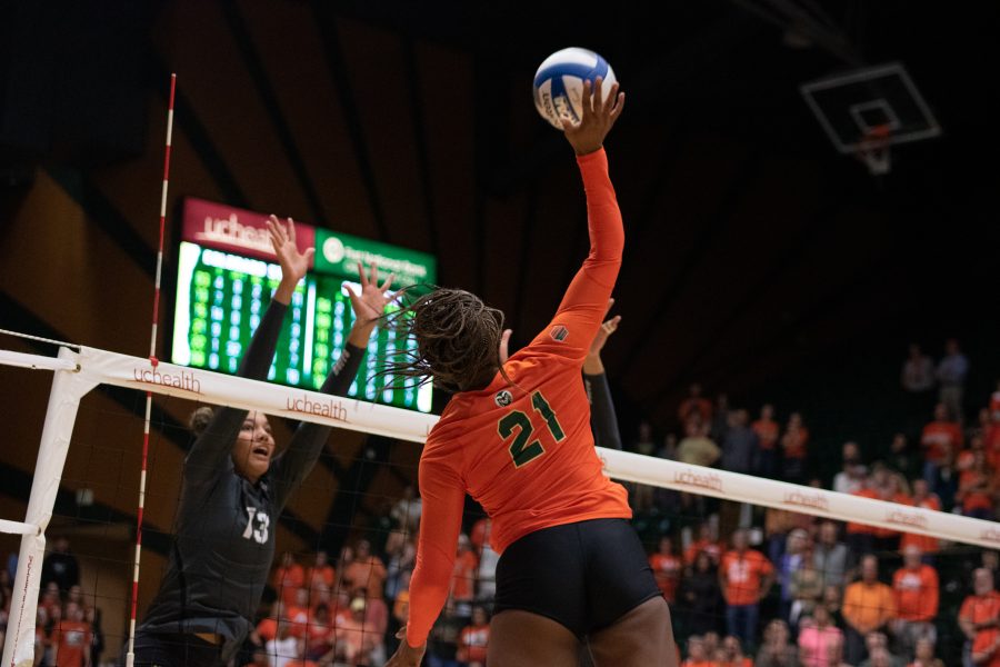 Jessica Jackson(21) spikes the ball down on her opponents, as the Colorado State Rams take on the University of Colorado Boulder Buffs at home. The Rams defeat the Buffs three sets to zero. (Devin Cornelius | Collegian)