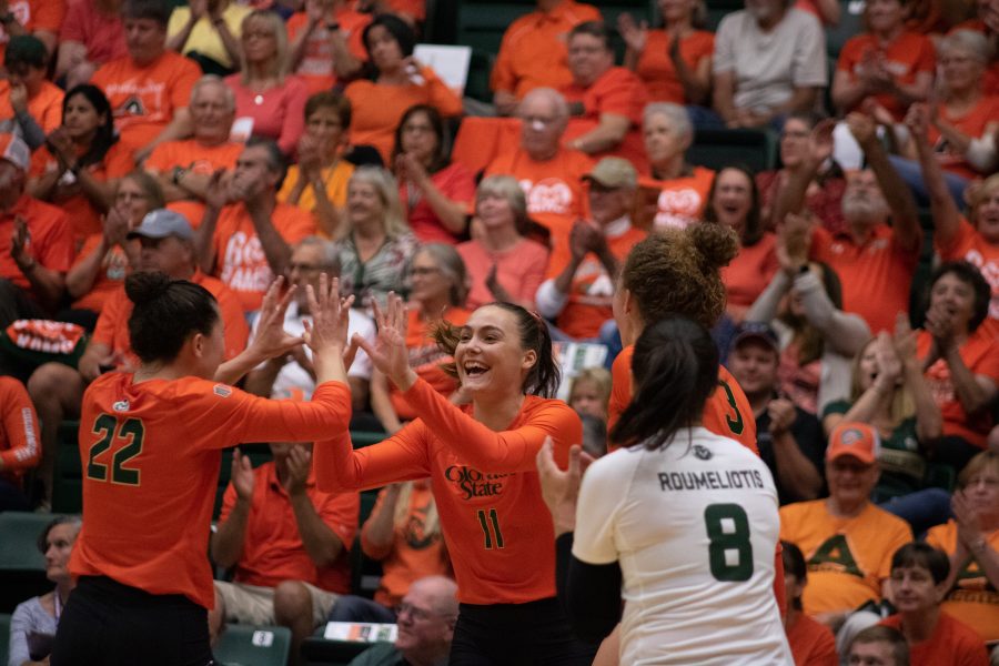 Katie Oleksak (22) and Paulina Hougaard-Jensen (11) high five after a great play, as Colorado State takes on the University of Colorado Boulder at home. The Rams defeat the Buffs three sets to zero. (Devin Cornelius | Collegian)