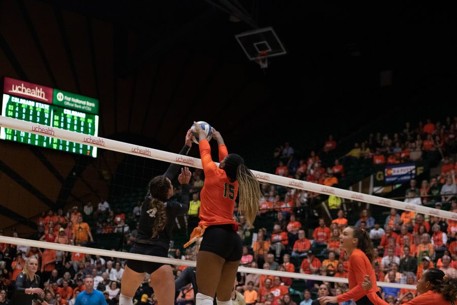 Breana Runnels (15) blocks a tip from a University of Colorado Boulder player during Colorado State's game against the Buffs. Colorado State wins three sets to zero. (Devin Cornelius | Collegian)