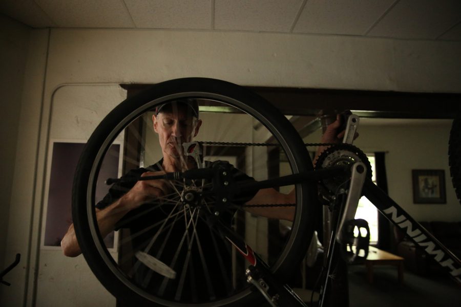 David Stitzel works on refurbishing a bike in his home near Colorado State Universitys campus in central Fort Collins. Stitzel refurbishes and fixes bikes that he later donates to people in need through a partnership with the FoCo Cafe. (Forrest Czarnecki | The Collegian)