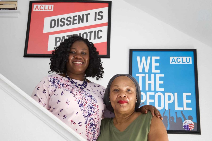 Joy Enginnaya and Savannah Brown in front of posters from the American Civil Liberties Union in Browns home September 17. Enginnaya and Brown, in an interview, discussed their work to create a “Living While Black” club on campus, which is associated with the ACLU. (Ryan Schmidt | Collegian)