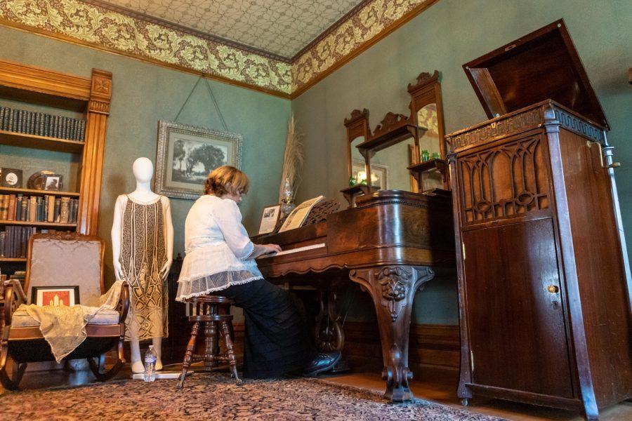 Member of the Poudre Landmark Foundation  Evelyn Reuter plays a square grand piano in one of the rooms inside the Avery House on Mountain Avenue. The Avery House was originally built in 1879, receiving its National Register as a historically significant landmark in 1972. (Brooke Buchan | Collegian)