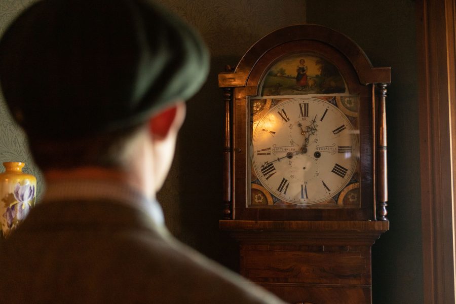 High school student and Avery House volunteer Blake Bergersen admires an old clock inside the front room of the Avery House Sept. 14. Bergersen wishes to attend college in Texas for watchmaking and said this clock is his favorite part of the entire home. The Avery House was originally built in 1879, receiving its National Register as a historically significant landmark in 1972. (Brooke Buchan | The Collegian)
