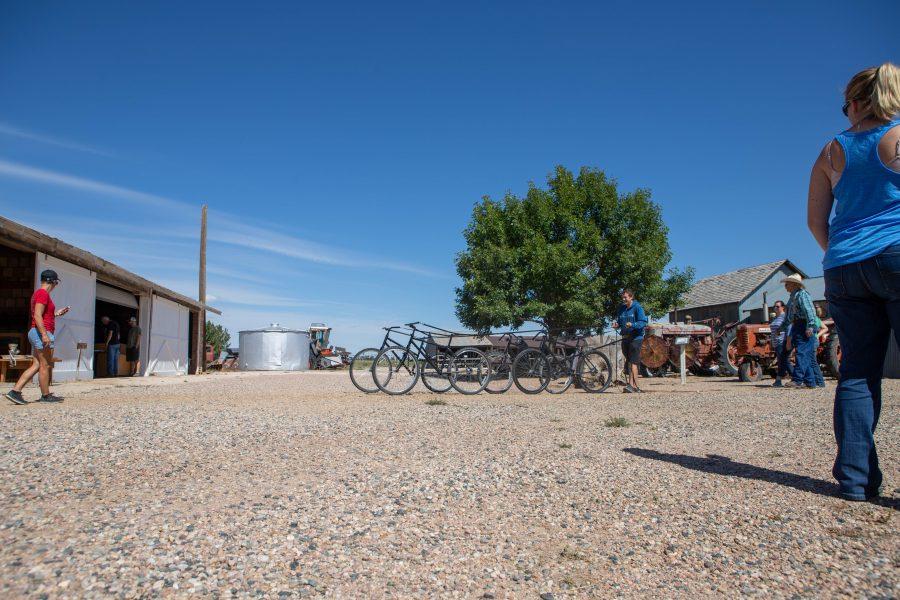 Visitors at the Centennial Bee Farm’s Pioneer Days practice using a bike-pulley system that mimics what it would be like to lead a group of horses. (Brooke Buchan | Collegian)