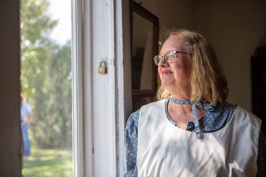LeeAnn Bee, a volunteer at the Centennial Bee Farm and wife of Arthur Bee, stands inside the well-preserved 1864 home. This is the original structure that the Bee family first settled and grew up in, in Northern Colorado. (Brooke Buchan | Collegian)