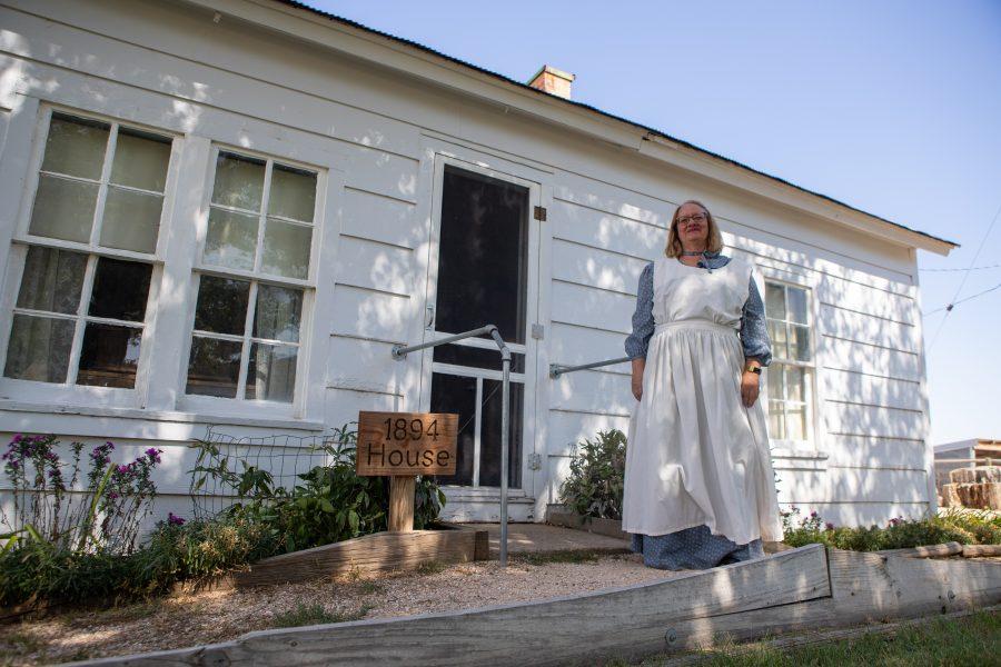 LeeAnn Bee, a volunteer at the Centennial Bee Farm and wife of Arthur Bee, stands in front of the well-preserved 1864 home. This is the original structure that the Bee family first settled and grew up in in Northern Colorado. (Brooke Buchan | Collegian)