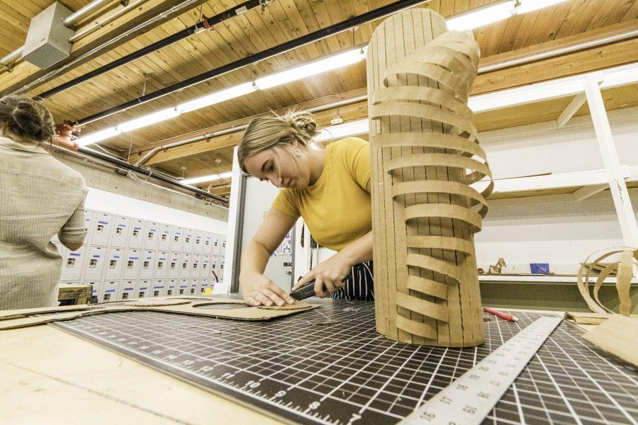 Sophomore Amanda Rooms cuts out cardboard circles in her Art 170 foundations of 3D class. "I want to go into art therapy because I've always loved art and always wanted to work with people with special needs," Rooms said. "This is the perfect combination." (Brooke Buchan | The Collegian)