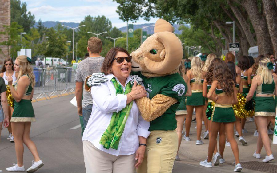 Cam the Ram gives University President Joyce McConnell a kiss. (Devin Cornelius | Collegian)