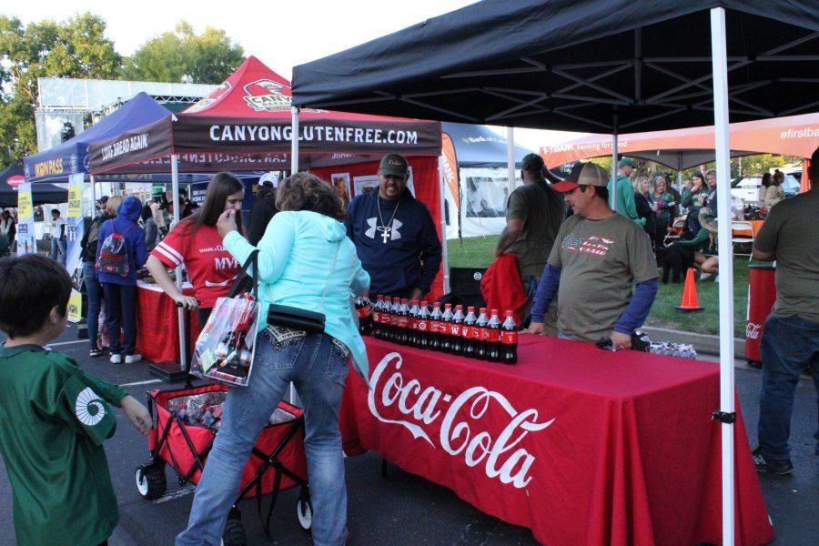 In the tailgate walk, there were many stations set up giving away free prizes to participants and winners. Coca-Cola had a booth set up where anyone could walk up and just take a nice cold drink. (Asia Kalcevic | Collegian) 
