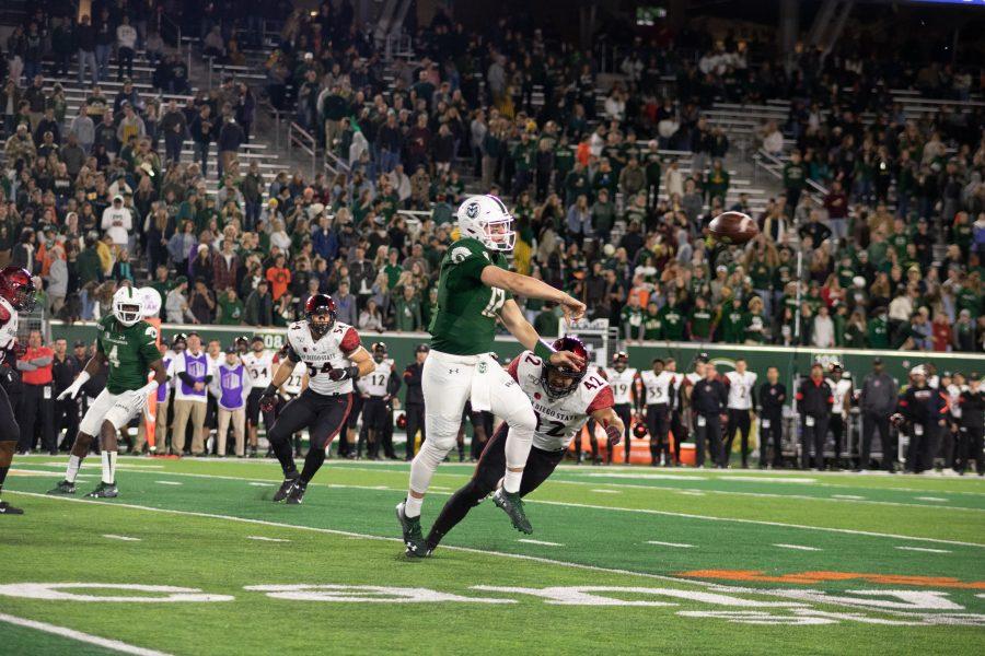 Patrick O'Brien(12) throws while on running from San Diego State defenders, during Colorado State's homecoming game against SDSU. CSU loses 24-10 (Devin Cornelius | Collegian)