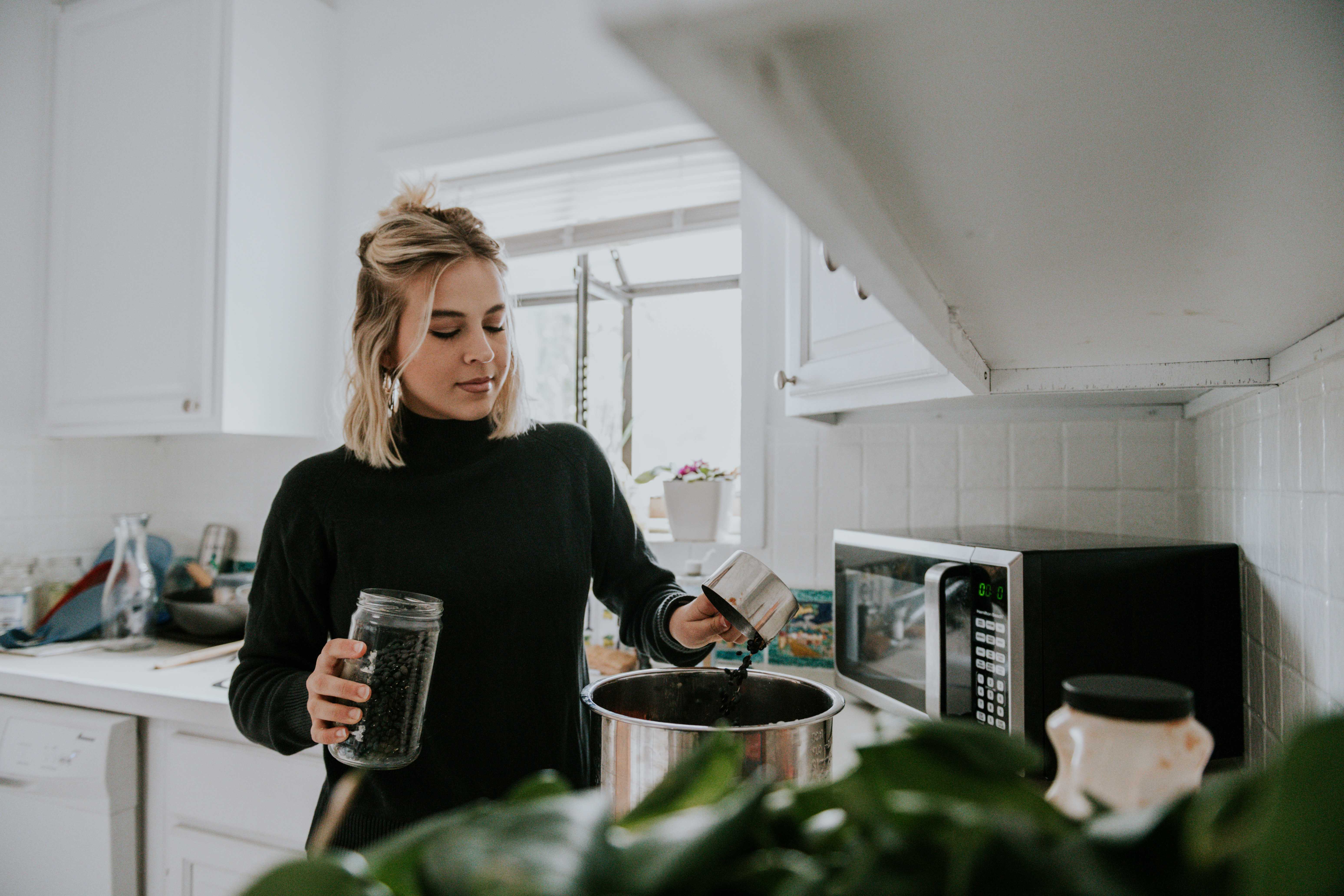 Woman is cooking slow cooker black bean soup