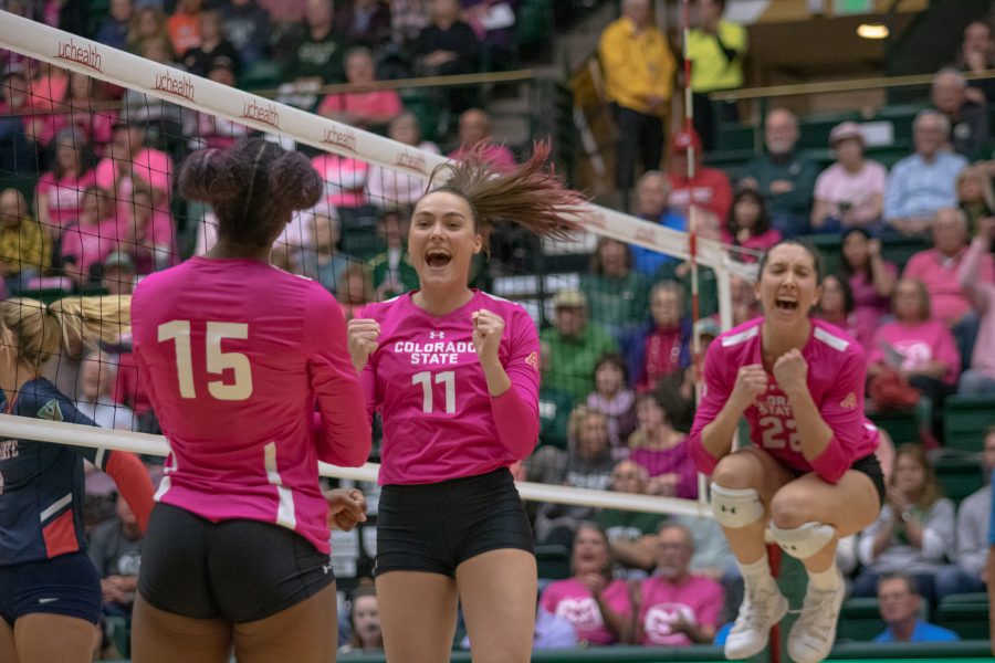 Breana Runnels(15), Paulina Hougaard-Jensen(11) and Katie Oleksak(22) celebrate after Paulina scores a point for Colorado State, during the Pink Out game at Moby arena vs Fresno State. CSU sweeps FSU three sets to zero. (Devin Cornelius | Collegian)