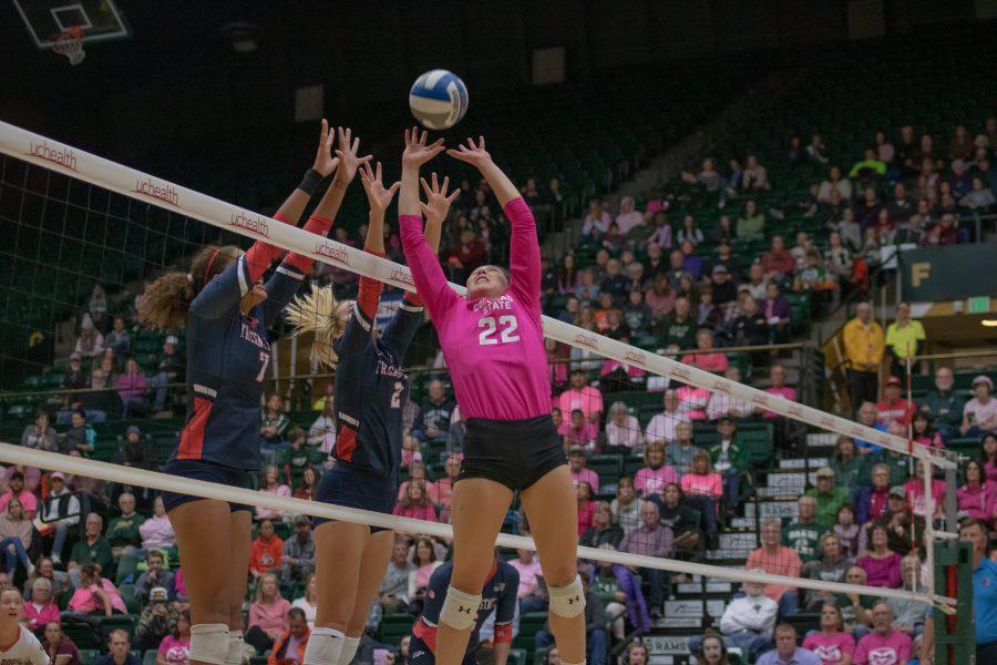 Colorado State University volleyball player Katie Oleksak (22) sets the ball away from Fresno State players during the Colorado State Pink Out game against Florida State University, Oct. 10, 2019. CSU won three sets to zero. (Devin Cornelius | The Collegian)