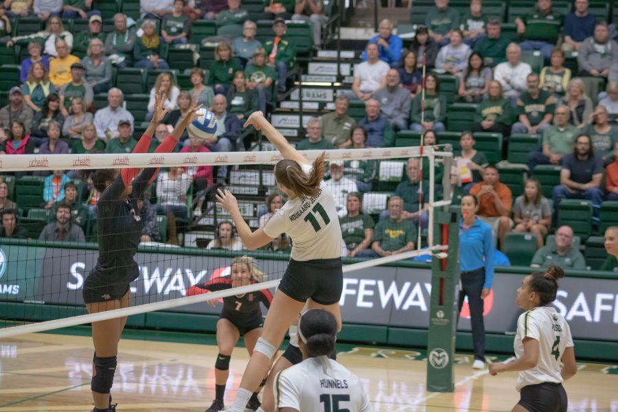 Paulina Hougaard-Jensen(#11) spikes the ball down on the San Diego State side as Colorado State battles SDSU at home. CSU wins three sets to zero. (Devin Cornelius | Collegian)