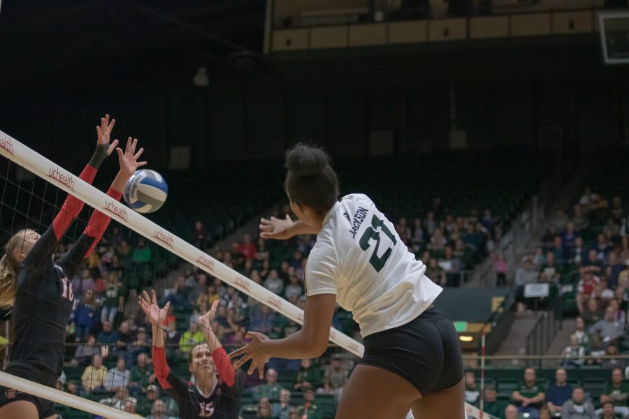 Jessica Jackson(#21) spikes the ball down on the San Diego State side as Colorado State battles SDSU at home. CSU wins three sets to zero. (Devin Cornelius | Collegian)