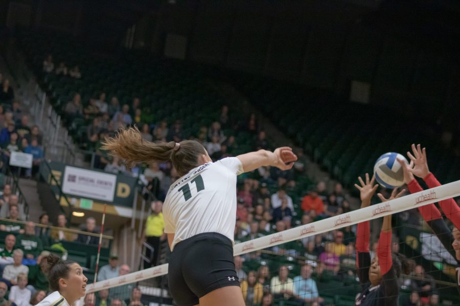 Paulina Hougaard-Jensen(#11) spikes the ball off a San Diego State defender, as Colorado State plays SDSU at home. CSU wins three sets to zero. (Devin Cornelius | Collegian)