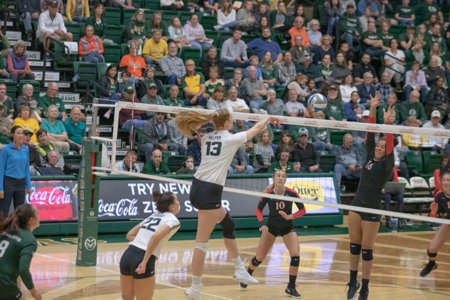 Kirstie Hillyer(#13) spikes the ball down on San Diego State's side of the court for a Colorado State point, during CSU's home game vs SDSU. CSU sweeps SDSU. (Devin Cornelius | Collegian)