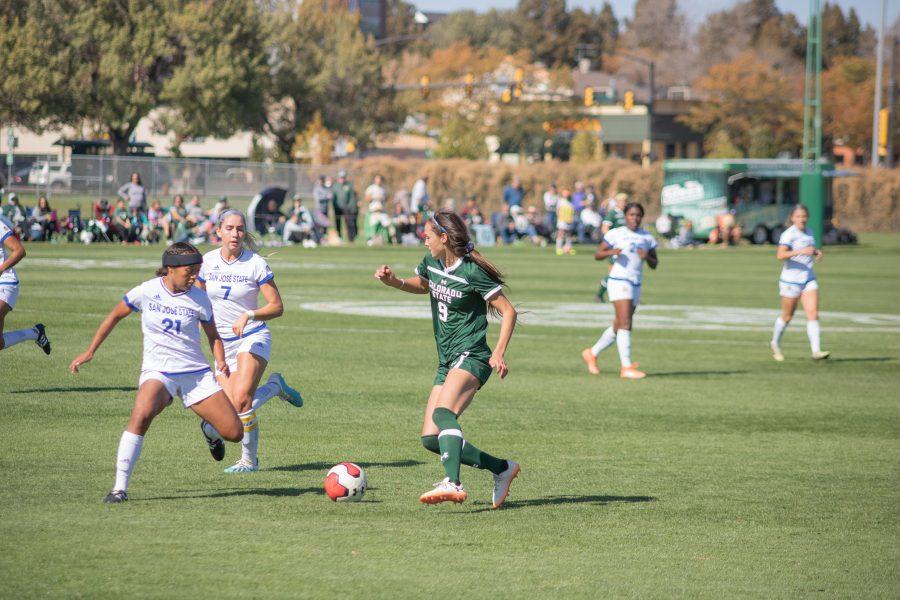 Grace Armstrong (9) looks to pass to a teammate, while surrounded by San Diego State Players, as Colorado State plays SDSU at home. CSU defeats SDSU two to one. (Devin Cornelius | Collegian)