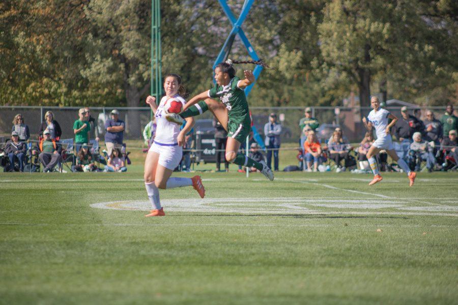 Alyssa Yoshida(#16) leaps into the air and catches the ball with her foot, as Colorado State battles San Diego State, at home. CSU wins two goals to one. (Devin Cornelius | Collegian)